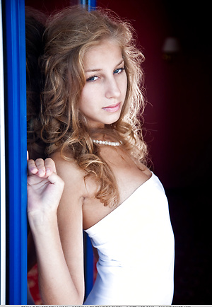 Erika F stays dressed up indoors and strips to show her long legs and sexy tits