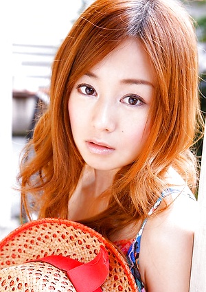 Red headed asian cutie posing in a floral printed dress