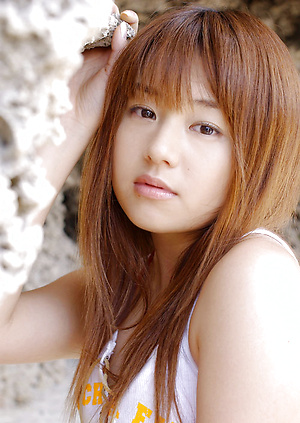 Adorable asian chick posing in her dainty bikini at the beach