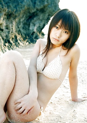 Cute asian babe in orange lace lingerie and black stockings