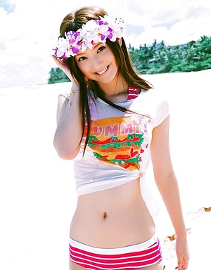 Long haired asian cutie having fun in a striped hot pink bikini