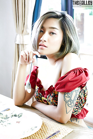 Asian solo girl Apple rubs her bush on a table after going topless