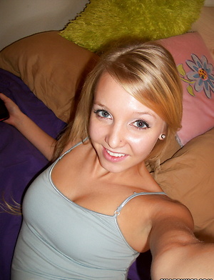 Blonde girlfriend takes selfshot pictures in bed of her perky teenage tits and tight little pussy