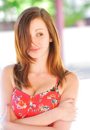 American redhead in a red dress posing naked